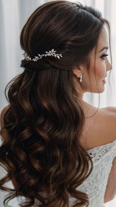 a woman with long hair wearing a wedding dress and a tiara on her head