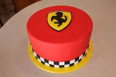 a red and yellow cake sitting on top of a table