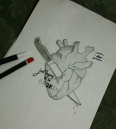 a drawing of a human heart with a knife in it's mouth and writing on the paper