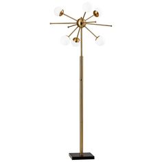 a floor lamp with four balls on it and three lights on the base, all in gold