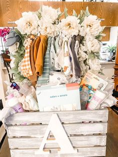 a wooden crate filled with clothes and flowers