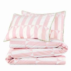 pink and white bedding with green piping on the pillowcase, two pillows and one duvet cover