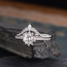 a diamond ring sitting on top of a rock