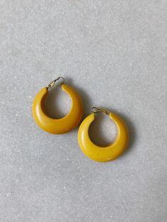 vintage mustard colored resin/plastic hoop earrings not sure if these are Bakelite clip on earrings super comfortable! Excellent vintage condition length- 1 1/2 inches era 1980s Handmade Vintage Yellow Earrings, Vintage Handmade Yellow Earrings, Vintage Yellow Brass Jewelry, 1970s Southern Vintage Earrings Jewelry, Vintage Yellow Resin Jewelry, 80's Earrings Vintage, Retro Clip-on Hoop Earrings, Midcentury Print, 1970’s Earrings