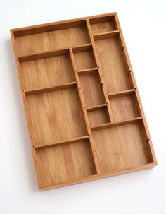 an empty wooden tray with compartments on it