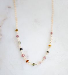 Bring some color and joy into your life with natural Tourmaline gemstones! Known to spark inspiration and happiness, this crystal is believed to build self-confidence and reduce fear. It's also thought to balance yin-yang energies and aid in detoxification. Plus, it's the perfect birthstone gift for those born in October.Our handcrafted necklace features genuine, faceted Tourmaline stones in a variety of colors (black, green, brown, and pink). Each necklace is unique with its own color pattern, Healing Tourmaline Gemstone Bead Necklaces, Spiritual Tourmaline Gemstone Bead Necklaces, Spiritual Tourmaline Gemstone Bead Necklace, Multicolor Spiritual Necklace For Everyday Wear, Spiritual Multicolor Necklaces For Everyday Wear, Multicolor Spiritual Necklace For Everyday, Healing Tourmaline Gemstone Necklace, Spiritual Multicolor Necklace For Everyday, Tourmaline Gemstone Beaded Necklace For Gift