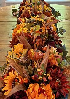 an arrangement of sunflowers and other flowers is arranged on the floor in front of a door