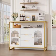 a white and gold sideboard in a living room with open shelves on the wall