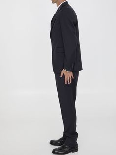 This two-piece suit is made of blue virgin wool with a hint of shine. It features a single-breasted jacket with peaked lapels and a brooch on the lapel, as well as a front button closure, two flap pockets, a chest welt pocket, and buttoned cuffs. The straight-leg pants have a zip and button closure, two side welt pockets, two rear buttoned welt pockets, and belt loops. Regular fit. The model is 189cm tall and wears size IT 50. Size nationality: IT Single breasted Peaked lapels Front closure Stra Classic Pantsuit With Suit Collar, Classic Pantsuit With Suiting Fabric, Tailored Three-piece Suit With Notch Lapel And Pressed Crease, Lapel Collar Suit With Hidden Button Closure, Suits With Hidden Button Closure And Lapel Collar, Notch Lapel Three-piece Suit With Pressed Crease, Three-piece Suit With Notch Lapel And Pressed Crease, Formal Single Breasted Pantsuit, Professional Three-piece Suit With Hidden Buttons