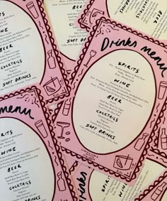 pink menus with black writing on them