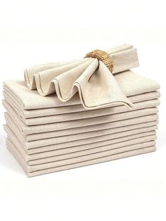 a stack of folded napkins on top of each other with a knot at the end