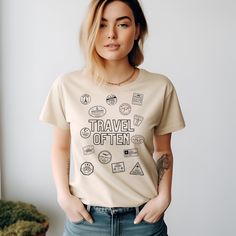 Embark on a journey around the world with our Travel Often Passport Stamps Travel Shirt, designed for the avid traveler and adventure seeker. Crafted from premium heavy cotton, this unisex tee ensures both comfort and durability for your explorations. With multiple color choices available, it's the perfect apparel for any wanderlust-driven adventure or travel-inspired outfit. About: The unisex heavy cotton tee is the basic staple of any wardrobe. It is the foundation upon which casual fashion gr Cotton Crew Neck T-shirt For Travel, Casual Short Sleeve Travel Tops, Casual Short Sleeve Tops For Travel, Graphic Tee With Letter Print For Travel, Graphic Print Short Sleeve T-shirt For Travel, Cotton Letter Print Travel Tops, Cotton Travel Tops With Letter Print, Cotton Letter Print Tops For Travel, Graphic Tee With Crew Neck For Travel