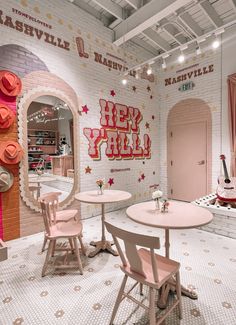 a room with pink furniture and decorations on the walls