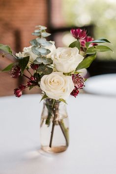 a vase filled with white flowers on top of a table