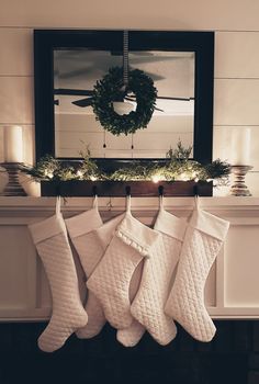 stockings hanging from a mantel in front of a mirror