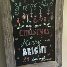 a chalk board with christmas decorations hanging from it's sides and the words merry and bright written on it