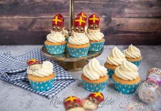 some cupcakes with white frosting and pirate hats on them next to other cupcakes