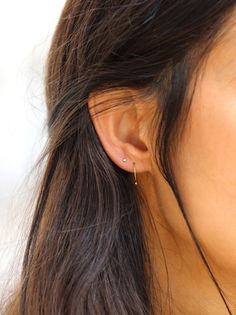 a close up of a person wearing a pair of ear piercings