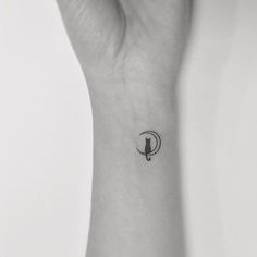 a black and white photo of a woman's wrist tattoo