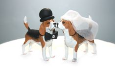 two figurines of beagle dogs dressed up as bride and groom