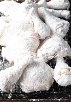 chicken wings on a cooling rack covered in powdered sugar