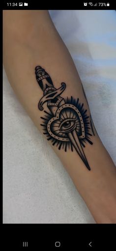 a person with a tattoo on their arm and an eye in the middle of it