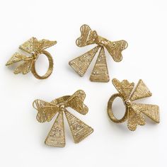 three gold rings with bows on them