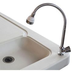 a sink with a faucet attached to it and a drain running from the side