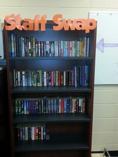 there is a book shelf with many books on it and a sign that says staff swap