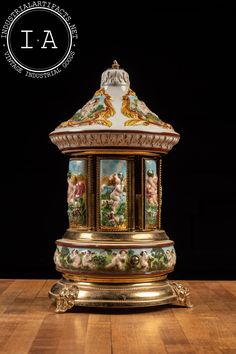 "Vintage Italian porcelain and Swiss movement music box carousel. This piece has pockets inside each of the door panels, typically used for cigarettes or lipstick. It features raised porcelain cherubs and gilt figural heads of the fertility deity Pan. The song that plays is \"Arrivederci Roma\" composed by Renato Rascel in 1955. The bronze or brass cherub finial on top has snapped off over time, but is still included with the piece. 7.5\" dia and 13\" H MM - 106401 - 062323 Please refer to photo American Literature Books, Antique Music Box, Music Box Ballerina, Music Box Vintage, Workout Routines For Beginners, Music Boxes, Door Panels, Crochet For Boys, Vintage Italian