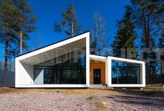 a small white house sitting on top of a gravel field