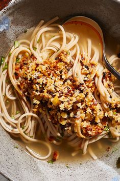 a white bowl filled with pasta and sauce