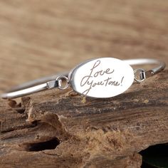 Actual Handwriting Bangle Bracelet, Memorial Bracelet, Sympathy Gift, Personalized Engraved Bracelet, Gift for Her, Signature Bracelet This laser engraved Stainless Steel bangle bracelet is a perfect gift for your Mom, Best Friend or Bride or Bridesmaids! or anyone you choose! Personalized with actual handwriting. This is engraved into high quality heavy gauge stainless steel. Engravable Portion: 15mm x 24mm Stainless Steel does NOT tarnish. How to order: 1. Add this item to your shopping cart 2 Meaningful Personalized Bangle Bracelet, Engraved Adjustable Bangle Name Bracelet, Inspirational Engraved Bangle Bracelet, Memorial Engraved Silver Bracelets, Personalized Hand Stamped Name Bangle Bracelet, Handwriting Bracelet, Signature Bracelet, Engraved Plates, Handwriting Jewelry