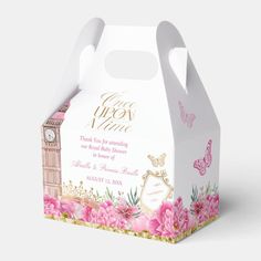 a white box with pink flowers and a clock on the front is decorated with gold lettering