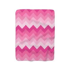 a pink and white chevroned blanket on a white background