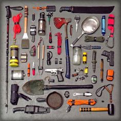 an assortment of tools are displayed on a gray surface with black border around the image