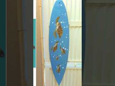 there is a surfboard with gold fish on it and another photo of the same board