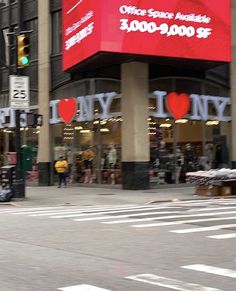 a man riding a skateboard down a street next to a tall building