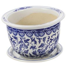 a blue and white cup with saucer on the side, filled with sugar in it