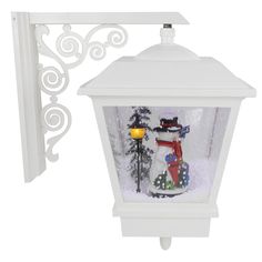 a white light fixture with a snowman on it's side and a christmas scene in the background