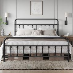 a black metal bed frame in a white bedroom