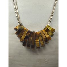 The Tiger Eye bib style necklace is a captivating and exotic piece of jewelry that showcases the unique and mesmerizing beauty of Tiger Eye gemstones. The warm and rich golden brown hues of the Tiger Eye gemstones evoke a sense of warmth and earthiness. Their chatoyant nature, with bands of light reflecting and shimmering across the surface, adds depth and dimension to the necklace. 16 inch Condition: New With Tags Excellent Condition, New Old Stock, Never Worn Fan Necklace, Vintage Tiger, Mesmerizing Beauty, Tigers Eye Gemstone, The Tiger, Style Necklace, Golden Brown, Tiger Eye, Charm Necklace