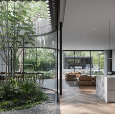 a living room filled with furniture next to a kitchen and dining area in a house