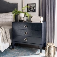 a bedroom with a bed, nightstand and pictures on the wall