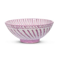 a purple and white bowl sitting on top of a table