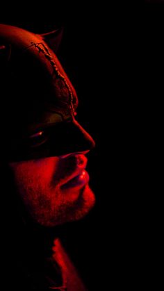 a man wearing a mask in the dark