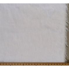 a ruler is next to a white fur rug