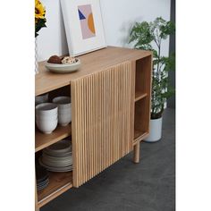 a wooden cabinet with plates and bowls on it