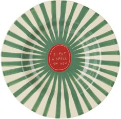 a green and white plate with red lettering that says i put a spell on you