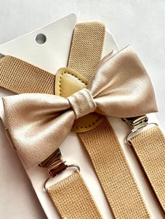 "Adorable bow tie, made of satin.   Size 6m-2yo: adjustable elastic  suspenders run from 16\"- 25\" long, bow tie's neck strap is about 14\" long; (adjustable), velcro closure Size 3yo-5yo: adjustable elastic suspenders run from 16\"-25\" long, bow tie's neck strap is about 15\" long; (adjustable), velcro closure Size 6yo-12yo: adjustable elastic suspenders run from 21\"-34\" long, bow tie's neck strap is about 16 1/2\" long; (adjustable), velcro closure Size adult up to 5'6\": adjustable elasti Adjustable Gold Bow For Black Tie Event, Elegant Party Belt With Bow, Adjustable Gold Bow Tie, Adjustable Gold Bow Tie For Black Tie Events, Adjustable Gold Bow Tie As A Gift, Adjustable Gold Satin Bow Tie, Elegant Adjustable Gold Belts And Suspenders, Classic Party Belts And Suspenders With Bow, Classic Gold Bow With Bow Tie Back